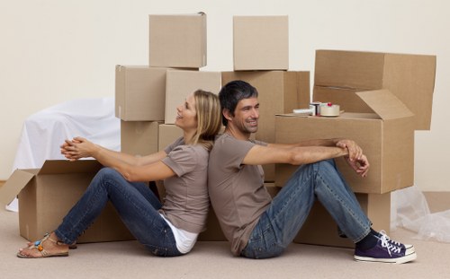 Mover carrying boxes during a professional house move