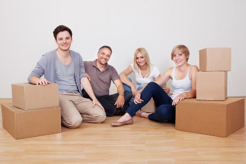 Moving crew handling items in a Notting Hill property with narrow access