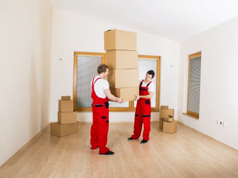 Boxes and furniture being loaded into a moving van in West London